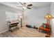 Bright bedroom featuring wood-look floors, a modern ceiling fan, and various decor at 3655 Candia Ave, North Port, FL 34286