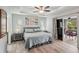 Inviting main bedroom with a tray ceiling, a king bed, and sliding glass doors to the patio at 3655 Candia Ave, North Port, FL 34286