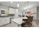 Bright kitchen featuring a large island with bar seating and stainless steel appliances at 3655 Candia Ave, North Port, FL 34286