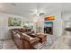 Spacious living room with a comfortable leather sofa, area rug, and bright, natural light at 3655 Candia Ave, North Port, FL 34286