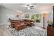 Bright living room boasts stylish furniture, a ceiling fan, and plenty of natural light at 3655 Candia Ave, North Port, FL 34286