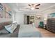 Bright primary bedroom featuring a tray ceiling, ceiling fan, and backyard patio access at 3655 Candia Ave, North Port, FL 34286