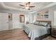 Spacious primary bedroom featuring tray ceilings, a ceiling fan, and ensuite bathroom access at 3655 Candia Ave, North Port, FL 34286