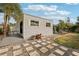View of shed showing the siding, pea gravel bed and stepping stone path, adjacent to the lawn at 3655 Candia Ave, North Port, FL 34286