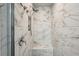 Elegant walk-in shower showcasing beautiful marble-style tiles and a built-in seat at 3655 Candia Ave, North Port, FL 34286