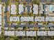 Overhead view of condo buildings, parking, mature trees, and a pool with shuffleboard courts at 4222 Richmere Dr # 4222, New Port Richey, FL 34652
