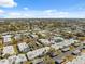 Wide aerial shot showcases a residential community with carports and verdant landscaping under a blue sky at 4222 Richmere Dr # 4222, New Port Richey, FL 34652