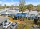 Aerial view of the villa showcasing its roof, two palm trees, and parking at 4222 Richmere Dr # 4222, New Port Richey, FL 34652