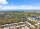 An aerial view of the community with a waterfront, showing proximity to scenic marshlands, bay waters, and the blue sky at 4222 Richmere Dr # 4222, New Port Richey, FL 34652