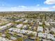 Sprawling community aerial view with lush landscaping, carports, and distant lake views under a sunny sky at 4222 Richmere Dr # 4222, New Port Richey, FL 34652