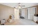This bedroom features a ceiling fan, two closets with bi-fold doors, and neutral walls and carpet at 4222 Richmere Dr # 4222, New Port Richey, FL 34652