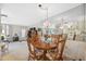 Dining area with mirrored wall, chandelier, and wood table set with floral accents at 4222 Richmere Dr # 4222, New Port Richey, FL 34652