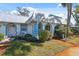 Charming condo featuring a metal roof, blue trim and covered front walkway with inviting curb appeal at 4222 Richmere Dr # 4222, New Port Richey, FL 34652