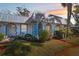 Villa with a white exterior, blue trim, and lush landscaping at 4222 Richmere Dr # 4222, New Port Richey, FL 34652
