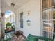Inviting front porch with brick flooring, welcome signs, seating, and view of the exterior at 4222 Richmere Dr # 4222, New Port Richey, FL 34652