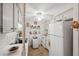 Well-lit white kitchen with plentiful cabinet storage, appliances, and space-saving washer at 4222 Richmere Dr # 4222, New Port Richey, FL 34652