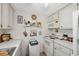 Efficient kitchen featuring white appliances, white cabinets, and charming decorative accents at 4222 Richmere Dr # 4222, New Port Richey, FL 34652