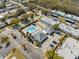 Aerial view of a community pool area with lounge chairs, landscaping, and adjacent buildings at 4222 Richmere Dr # 4222, New Port Richey, FL 34652