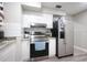 Kitchen with stainless steel fridge, stove and white cabinets at 4514 Porpoise Dr, Tampa, FL 33617