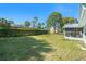 Expansive backyard with a privacy hedge and well-maintained lawn at 4662 Dewey Dr, New Port Richey, FL 34652