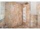 Modern bathroom features a glass shower with brown tile and built-in shelves at 4662 Dewey Dr, New Port Richey, FL 34652
