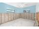 Blue bedroom with two windows, awaiting renovation at 4662 Dewey Dr, New Port Richey, FL 34652