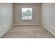 Cozy bedroom showcasing a window with blinds and carpet flooring at 518 Glenn Cross Dr, Ruskin, FL 33570