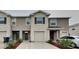 Attractive two-story townhome with attached garage, neutral colors, and manicured landscaping at 518 Glenn Cross Dr, Ruskin, FL 33570