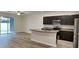 Open floor plan with a kitchen island, stainless appliances, and sliding door to the backyard at 518 Glenn Cross Dr, Ruskin, FL 33570