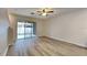 Bright living area with wood laminate floors and sliding glass doors to outdoor space at 518 Glenn Cross Dr, Ruskin, FL 33570