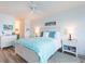 Comfortable bedroom with white furniture, blue accents and ceiling fan at 5505 Puerta Del Sol S Blvd # 427, St Petersburg, FL 33715