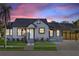 Charming single-story home featuring fresh landscaping, a driveway, and a covered carport at 600 26Th S Ave, St Petersburg, FL 33705