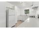 This bright kitchen has white appliances, cabinets, and countertops at 600 26Th S Ave, St Petersburg, FL 33705