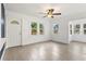 Bright living room boasts fresh paint, new floors, lots of windows, and a ceiling fan at 600 26Th S Ave, St Petersburg, FL 33705