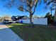 A side yard with a privacy fence, mature trees, and ample green space, providing a serene outdoor retreat at 600 26Th S Ave, St Petersburg, FL 33705