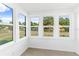 Cozy sunroom featuring an abundance of windows with comfortable furniture at 600 26Th S Ave, St Petersburg, FL 33705