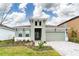 Well-maintained one-story home showcasing a two-car garage, verdant landscaping, and a sleek modern aesthetic at 6202 Hidden Branch Dr Dr, Apollo Beach, FL 33572