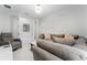 Cozy living room showcasing a comfortable gray sectional, neutral decor, bright lighting and modern accents at 6202 Hidden Branch Dr Dr, Apollo Beach, FL 33572