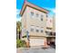 Charming multi-story townhome with neutral exterior, balcony and a two-car garage at 642 Blue Taverna Ln, Clearwater, FL 33756