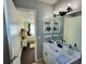 Bathroom with a mirror, single sink, and view to a bedroom at 6707 Thorman Rd, Port Charlotte, FL 33981