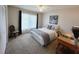 Well-lit bedroom features neutral tones, carpeted floors, and a cozy chair at 6707 Thorman Rd, Port Charlotte, FL 33981