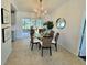 Cozy dining area with a glass table, chandelier, and sliding glass doors to the lanai at 6707 Thorman Rd, Port Charlotte, FL 33981