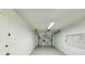 Clean garage with white walls and roll up door at 6707 Thorman Rd, Port Charlotte, FL 33981