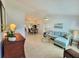 Bright living room featuring tile flooring, and a comfortable blue sectional sofa at 6707 Thorman Rd, Port Charlotte, FL 33981