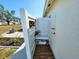 Outdoor shower with wood slats, white privacy screen, and landscaping at 6707 Thorman Rd, Port Charlotte, FL 33981