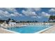 Outdoor pool with lounge chairs and umbrellas, perfect for relaxing on a sunny day at 6707 Thorman Rd, Port Charlotte, FL 33981