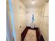 Walk-in closet with wood floor, wire shelving and an area rug at 6707 Thorman Rd, Port Charlotte, FL 33981