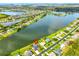 Stunning aerial view of a waterfront property nestled among lush greenery and tranquil lakes at 6725 Clair Shore Dr, Apollo Beach, FL 33572