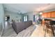 Bright and airy living room and dining area with modern furniture, a ceiling fan, and sliding glass doors to the lanai at 6725 Clair Shore Dr, Apollo Beach, FL 33572