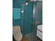 Bathroom featuring stand up shower with bright blue tile and river rock base at 7219 Williams S Dr, St Petersburg, FL 33705